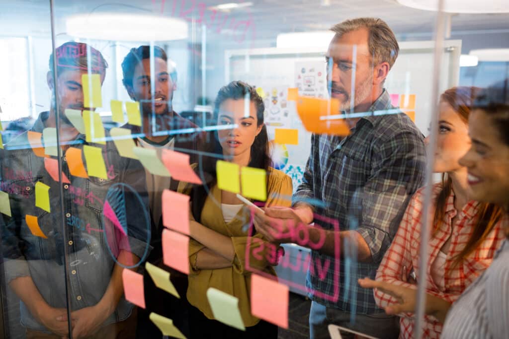 creative-business-team-looking-at-sticky-notes-for-agile-transformation-proocess