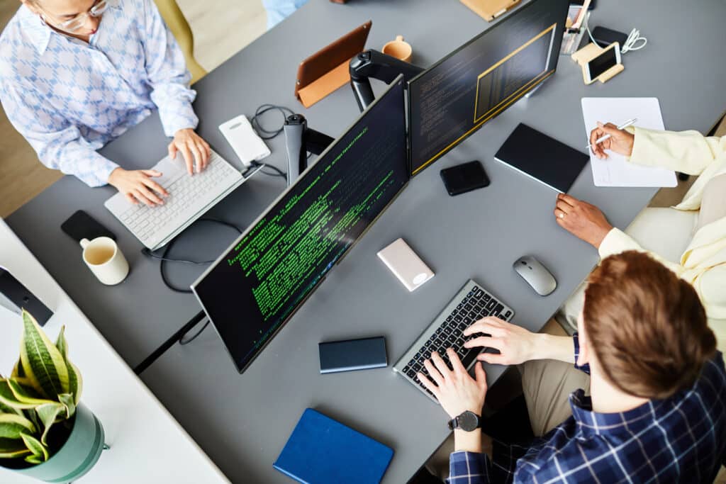 Programmers working on computers at office