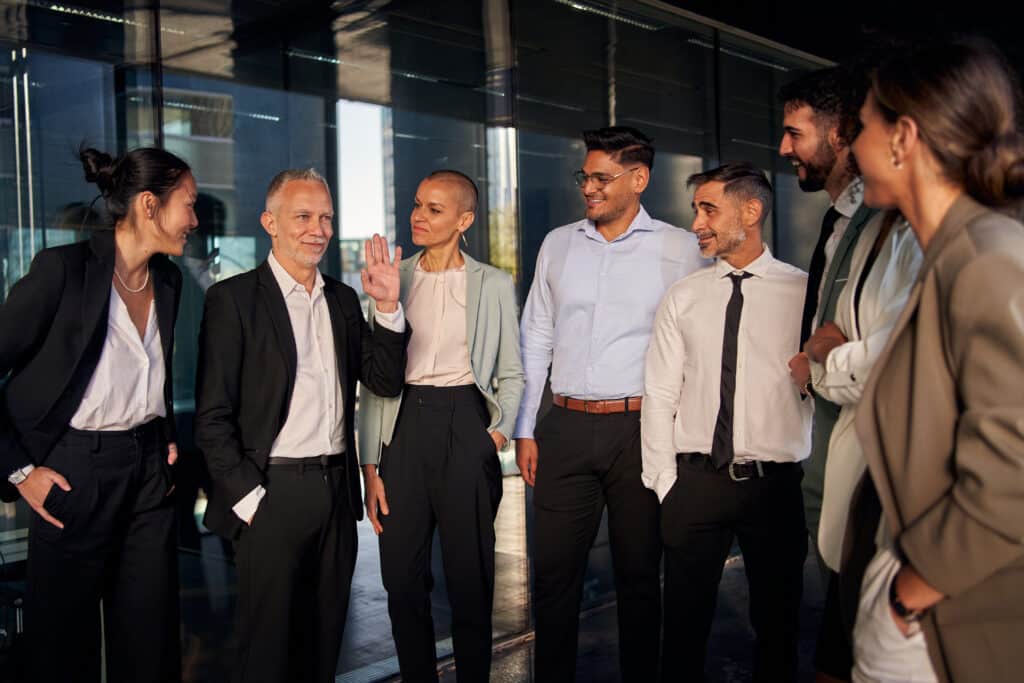 Group of office workers smiling looking at CEO - embrace agility concept