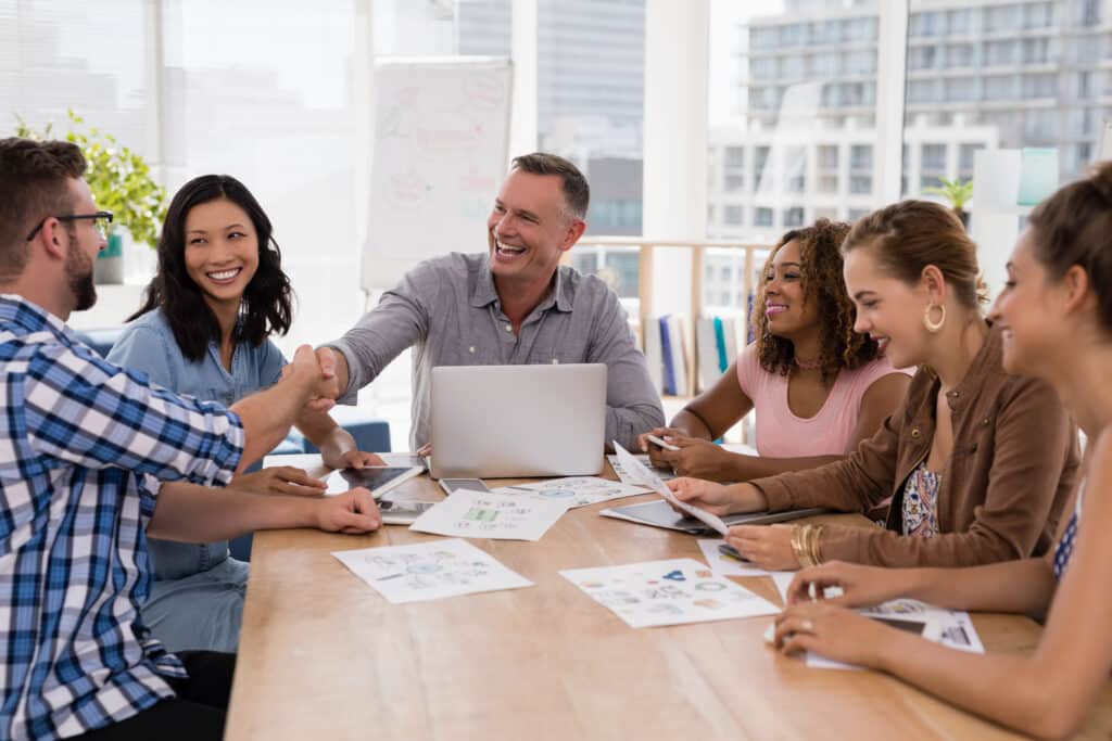culture of continuous improvement concept with executives shaking hands