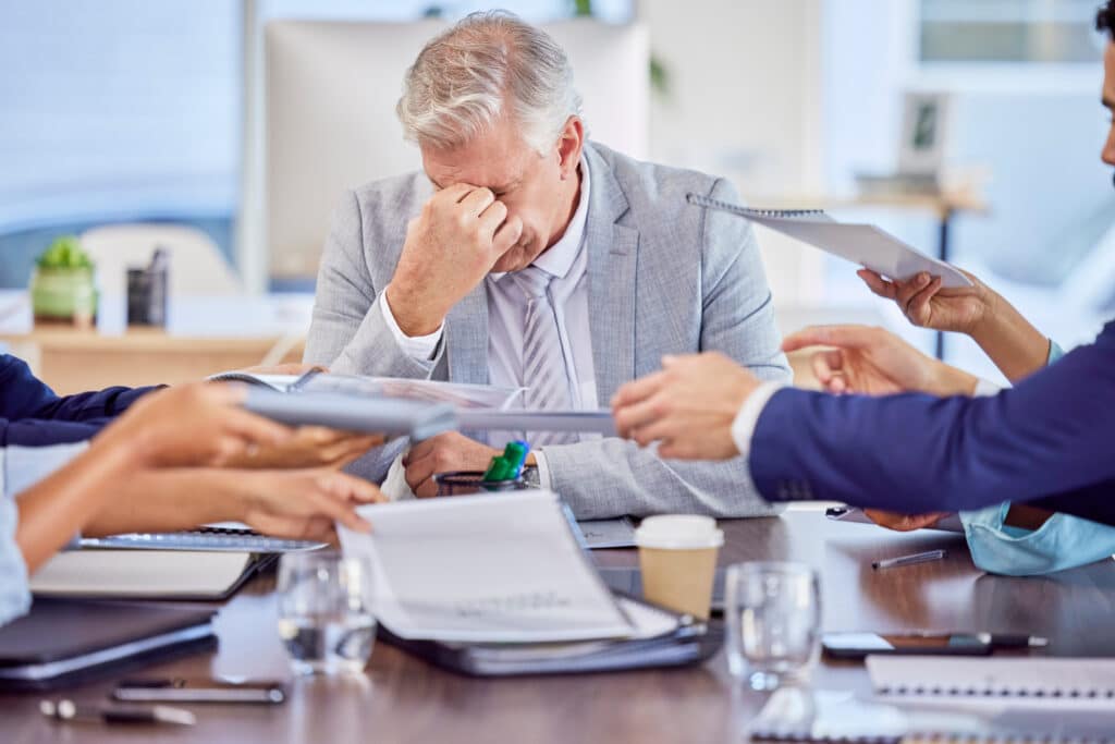 Failed Transformation Efforts concept with business owner holding his head from stress