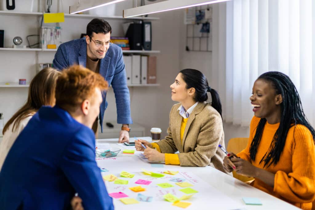 Team brainstorming session in a vibrant startup office, generating innovative ideas together.