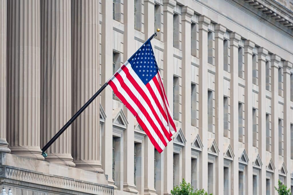 American flag displayed on the facade of a historic building.